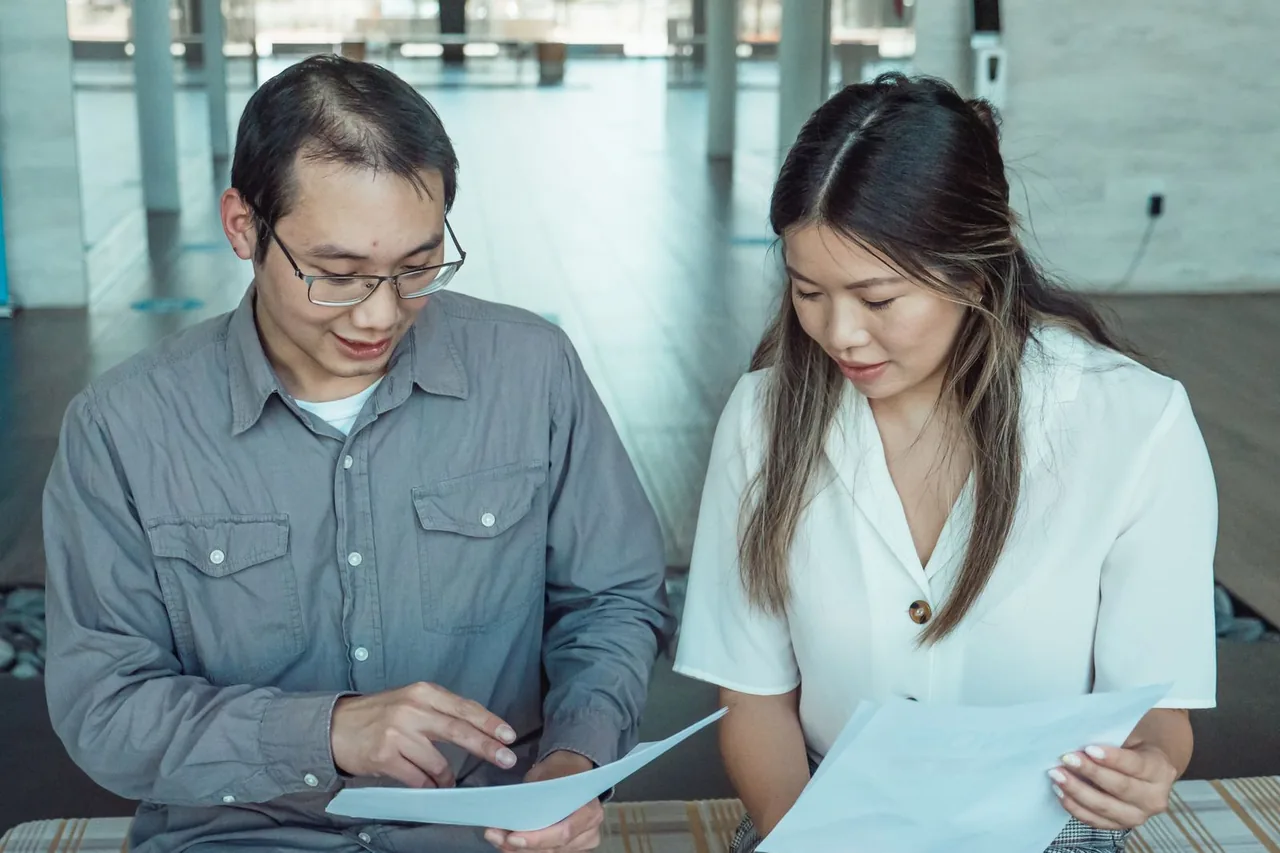 Two people reading through paperwork while preparing for a Virginia reckless driving court date
